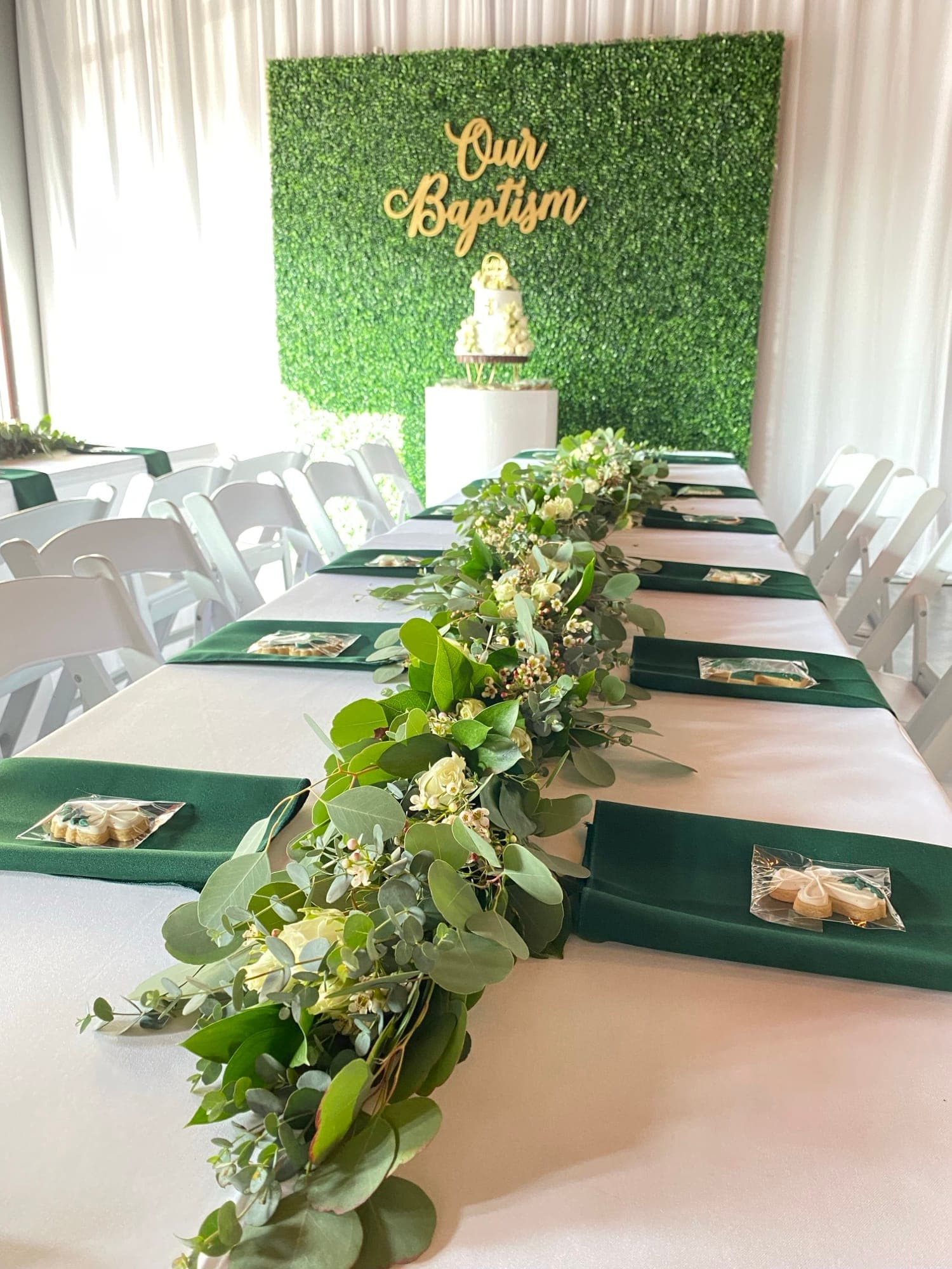 Long green and white botanical party table with fresh foliage centerpieces