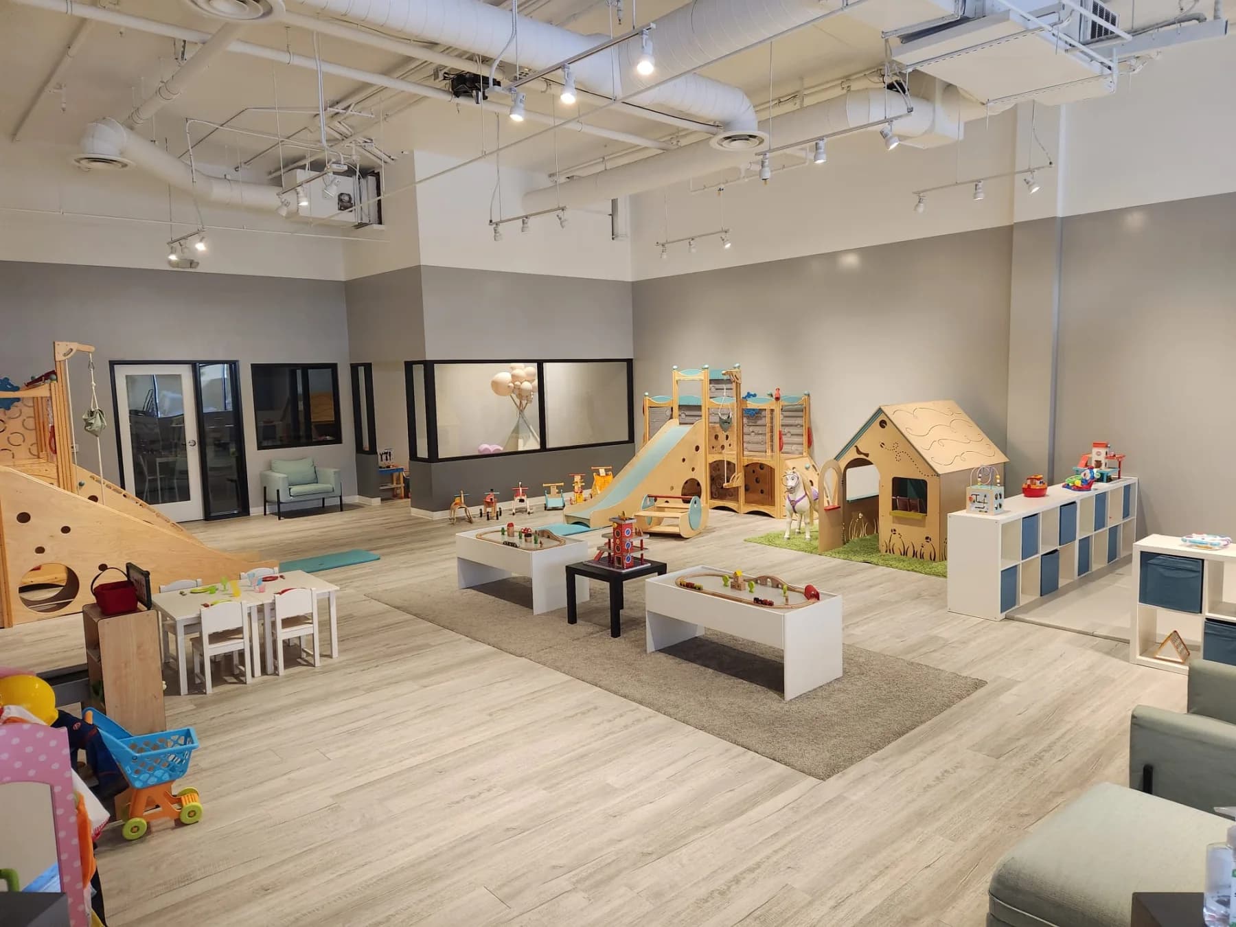 A wide view of the bright indoor playground at My Little Paris